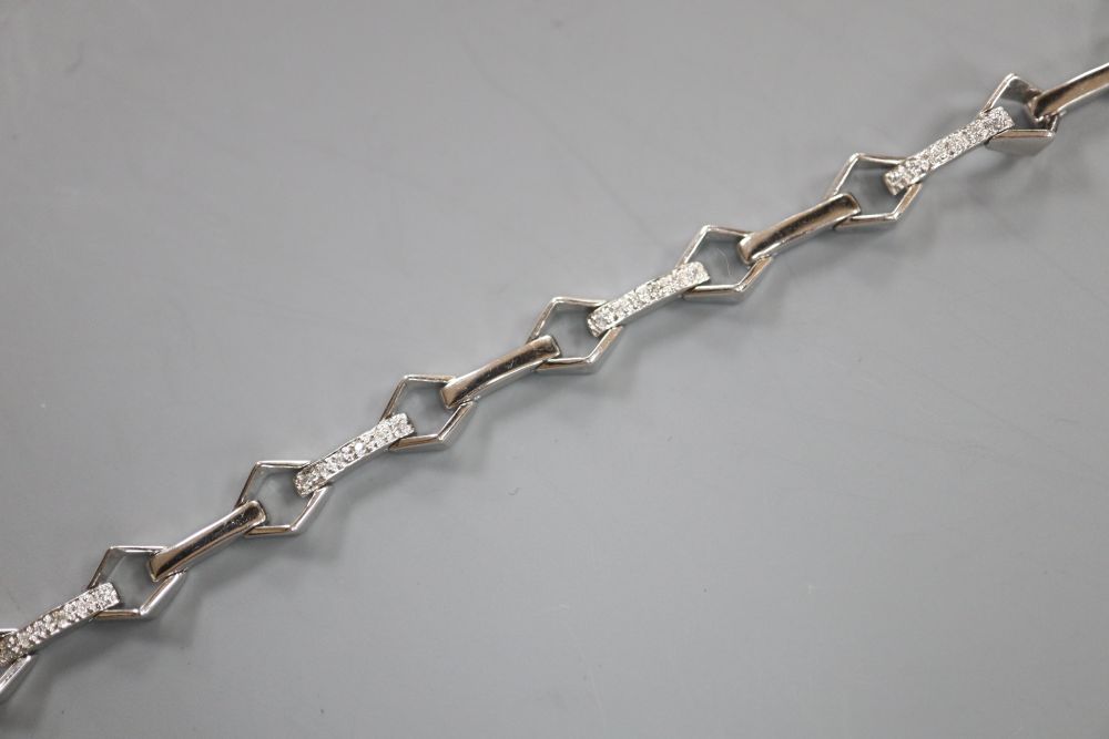 A modern 18k and diamond chip set baton and diamond shaped link line bracelet, 17.5cm, gross 9.5 grams.